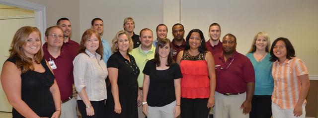 New staff members at Campbellsville University were introduced at a staff workshop July 27 in the Banquet Hall of the Badgett Academic Support Center. From left are: Front row – Elaine Tan, international activities assistant; James Clayton, transportation serviceman; Raquel Cunha, secretary for English as a Second Language Institute; Lauren Goodin, admissions counselor; Leigh-Ann Sadler, secretary for Office of Academic Support; Tammy Snyder, secretary for Early Childhood Education Program; David Wray, custodian; and Megan Kemp, secretary for the Learning Commons. Back row – Ann Wells, secretary for Center for International Education; Trevor McWhorter, custodian; Sean Anderson, assistant football coach; Jordan Netherland, resident director for Broadway Hall; Robert Bender, coordinator of audio/visual; Hunter Cantwell, assistant football coach; Scott Necessary, assistant to the vice president for admissions and student services and director of the dual credit program; and Shaun Marshall, custodian. (Campbellsville University Photo by Joan C. McKinney)