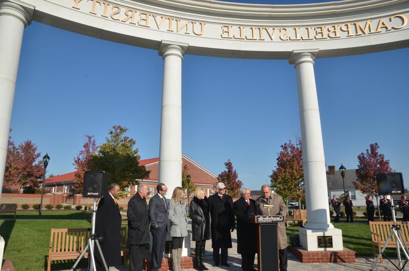 Campbellsville Mayor Tony Young, left, and Taylor County Judge/Executive Eddie Rogers proclaim Saturday, Oct. 26 as "Campbellsville University Day" at the dedication of Alumni & Friends Park, Noe Plaza. From left behind the mayor and judge are: Dr. Larry and Beverly Noe, Ashley Noe Meister and her husband Dr. David Meiser; CU President Michael V. Carter and Dr. Joseph Owens, chair of the CU Board of Trustees. (Campbellsville University Photo by Joan C. McKinney)