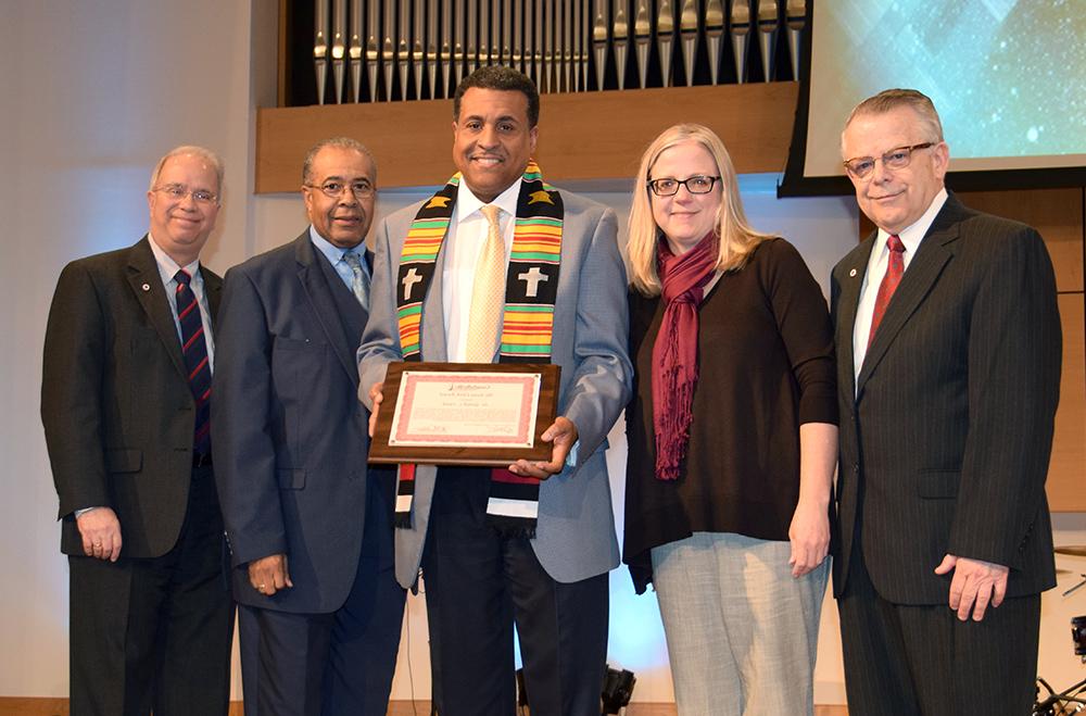 Dr. Gerald L. Smith, center, was awarded the CU Kente Cloth, given to those who have exemplified extraordinary servant leadership, after speaking at Campbellsville University's traditional Martin Luther King chapel service. From left in the presentation are: John Chowning, executive assistant to the president for government, community and constituent relations; Dr. Donna Hedgepath, vice president for academic affairs and professor of education; Dr. Joseph L. Owens, former CU board of trustee's chair; and Dr. Michael V. Carter, president.